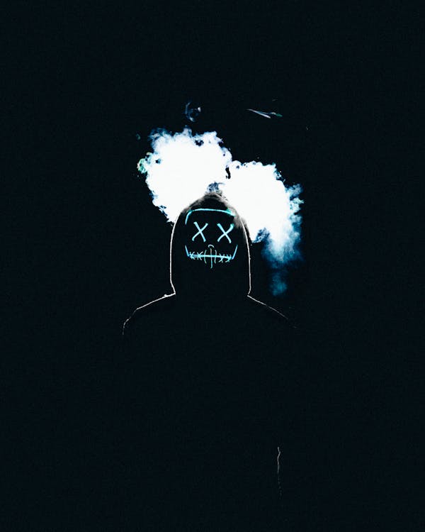 Silhouetted masked figure with smoke, dark atmosphere — anime editorial visual